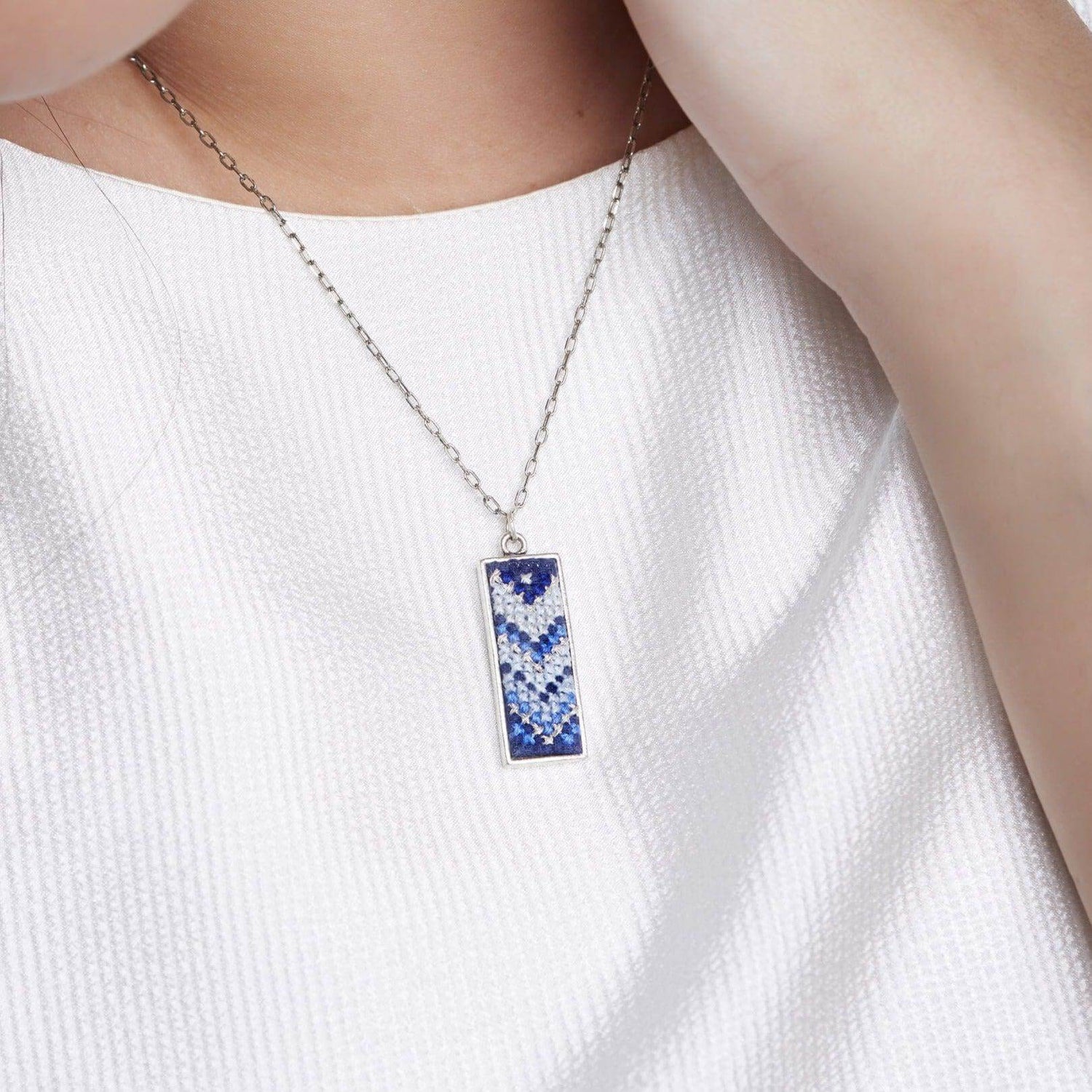 An image of ethical jewelry featuring a handcrafted pendant, showcasing Malaysian heritage and sustainable fashion.