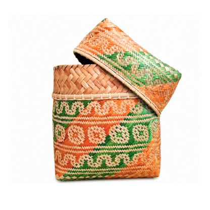 A hand-woven bamboo box with a matching lid, decorated with vibrant orange, green, and beige geometric patterns, set against a plain white background.