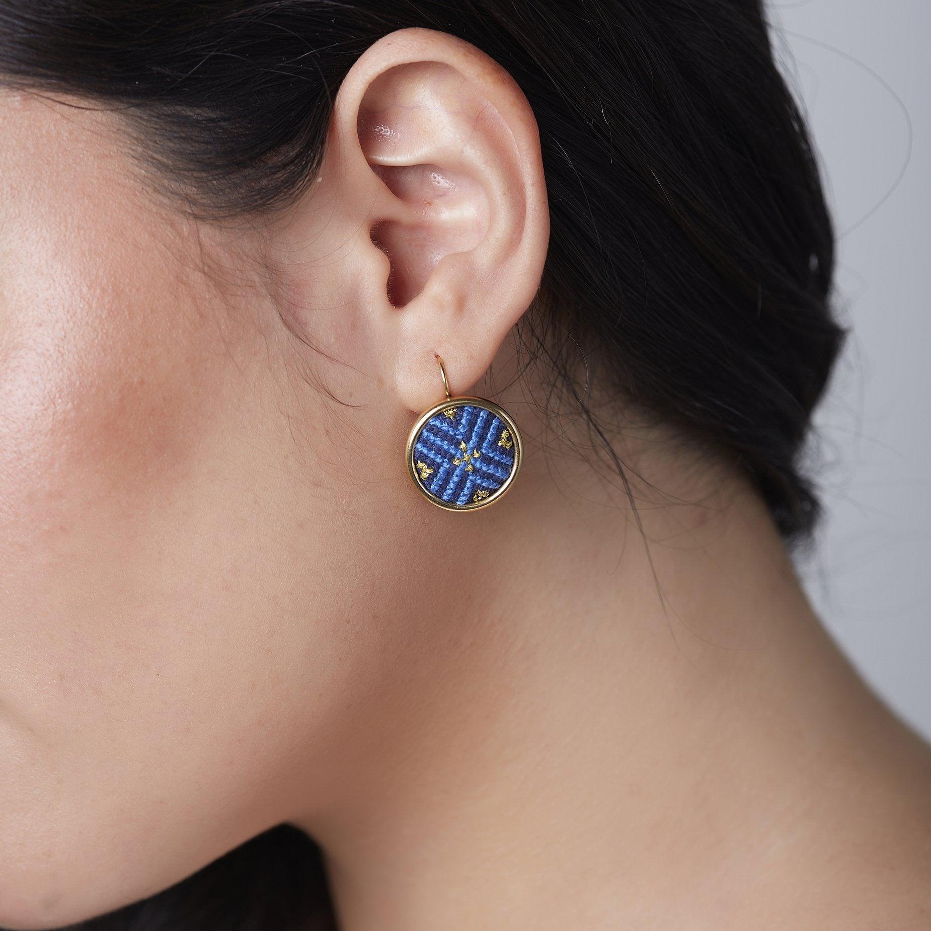 An image of a handcrafted earring showcasing Malaysian heritage, part of a sustainable fashion line promoting ethical jewelry through fair trade.