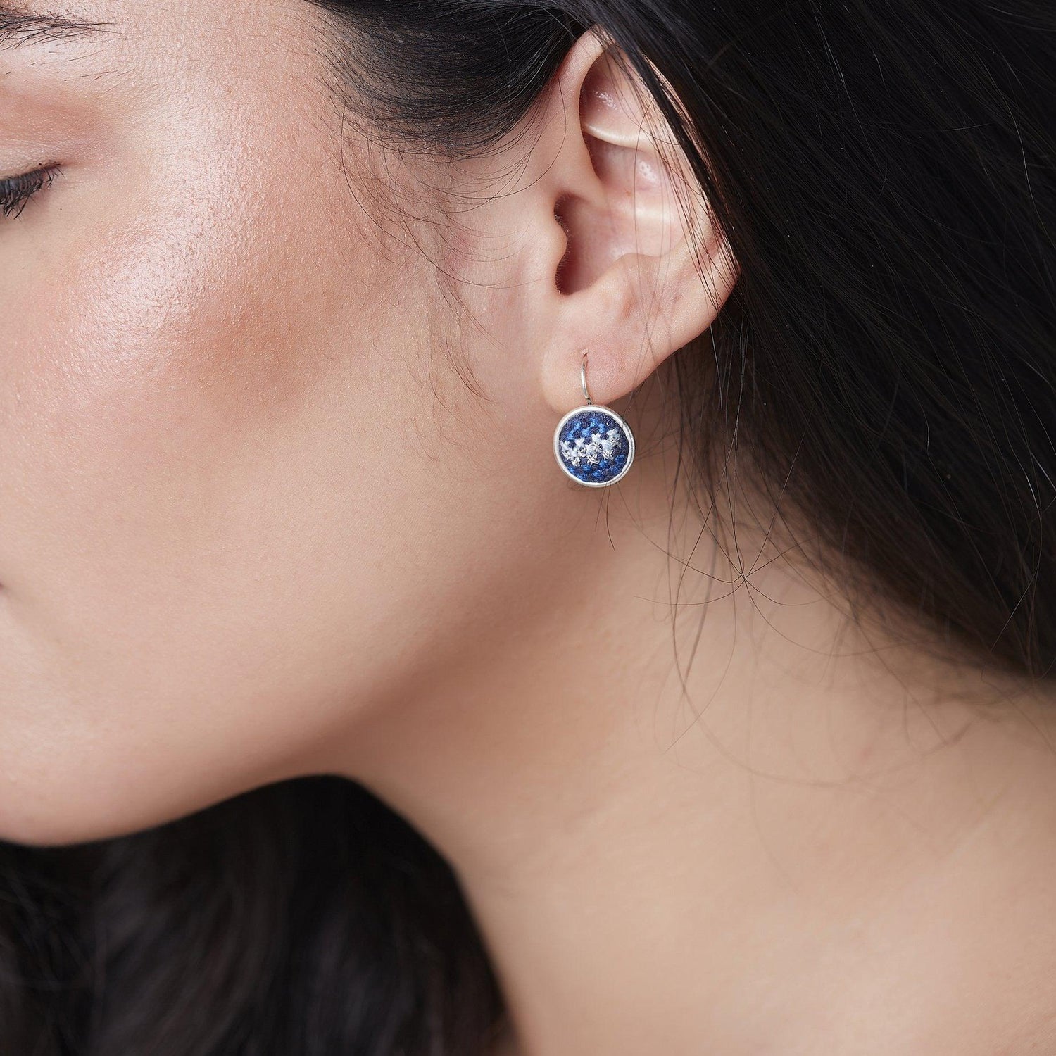 An image of ethical jewelry showcasing a handcrafted earring, representing Malaysian heritage and cultural preservation.